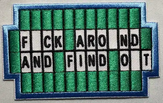 An embroidered patch resembling a vintage slot machine or arcade machine display, featuring green vertical stripes and white…
