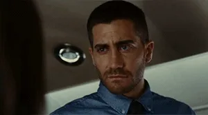 Six sequential frames show actor Jake Gyllenhaal in a blue shirt and tie, transitioning from a serious, skeptical expression…