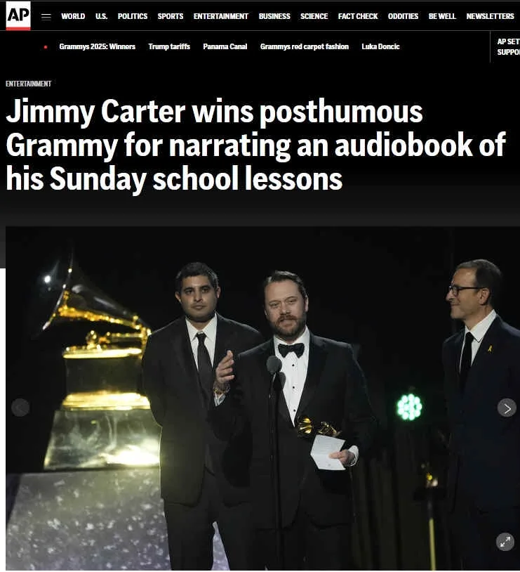 An AP News screenshot shows a man in a tuxedo holding a Grammy award on stage, flanked by two other men in suits, with a…