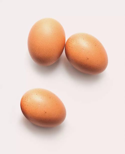 Three brown eggs are arranged on a plain white background. Overlaid text reads 'i'm not a fan of eggs'.
