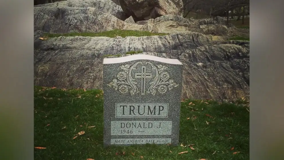 A gravestone with a cross and floral design, inscribed with 'TRUMP', 'DONALD J.', '1946', and the epitaph 'MADE AMERICA HATE…
