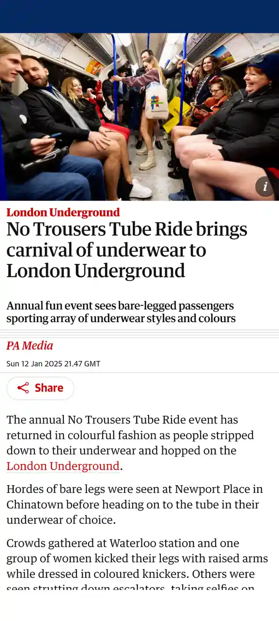 The image shows a crowded London Underground train carriage with numerous passengers sitting and standing, all wearing no…