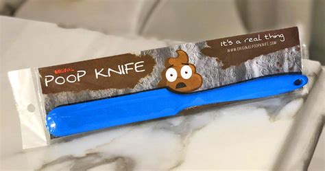 A blue plastic knife packaged in clear plastic with a brown cardboard header that reads 'POOP KNIFE' and features a cartoon…
