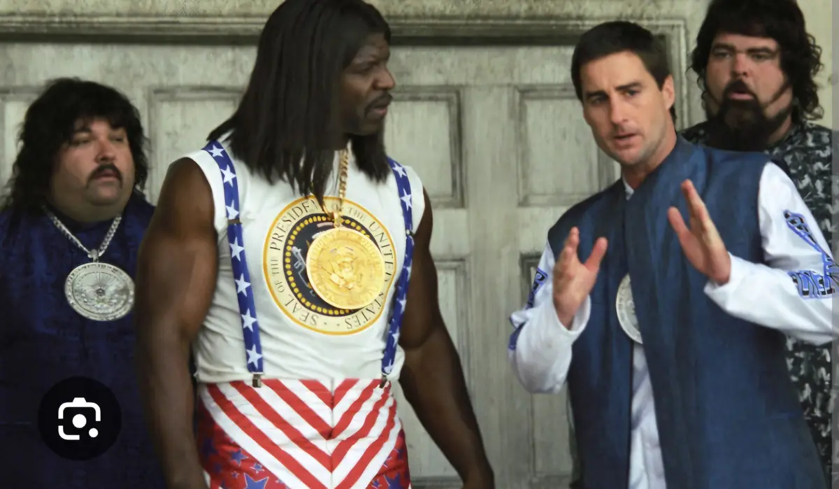 Four men in a scene from the movie 'The Nutty Professor' are dressed in patriotic, exaggerated costumes. The central figure…