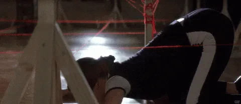 A woman in a dark blue athletic outfit with white stripes is shown in six sequential frames crawling on a wooden floor…