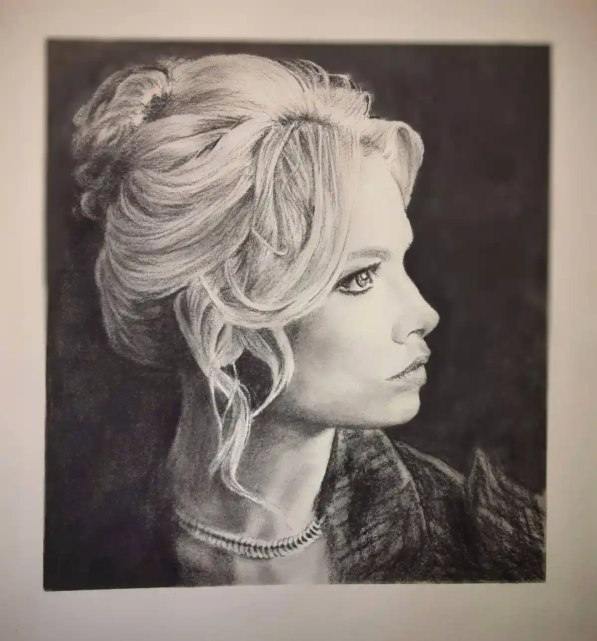 A detailed pencil sketch shows a woman's profile with intricately drawn hair styled in an updo, wearing a necklace and a…
