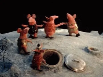 six sequential frames show clay mice dancing in a circle around a hole in the ground, with one mouse standing in the hole…