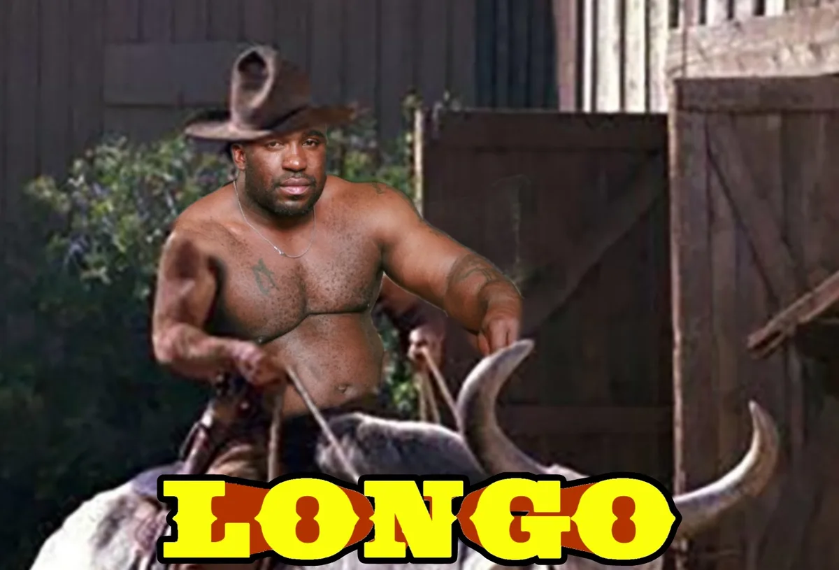 A shirtless, muscular Black man wearing a cowboy hat rides a bull with large horns, set against a wooden fence and foliage…