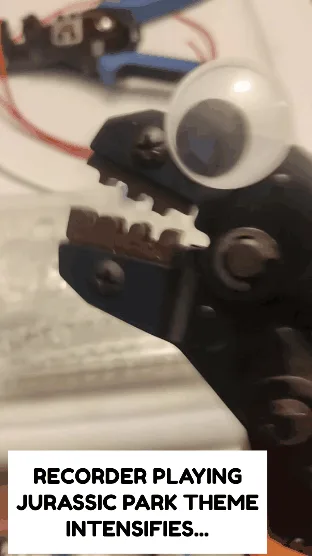 A sequence of six identical images shows a black wire stripper tool with a single googly eye glued to its jaws, positioned…