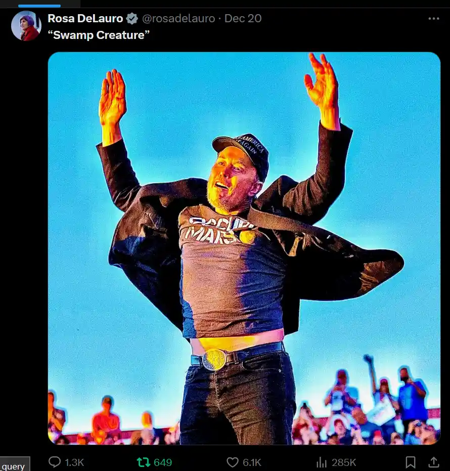 A man with a beard and a black cap that says 'AMERICA AGAIN' stands with arms raised against a bright blue sky, wearing a…