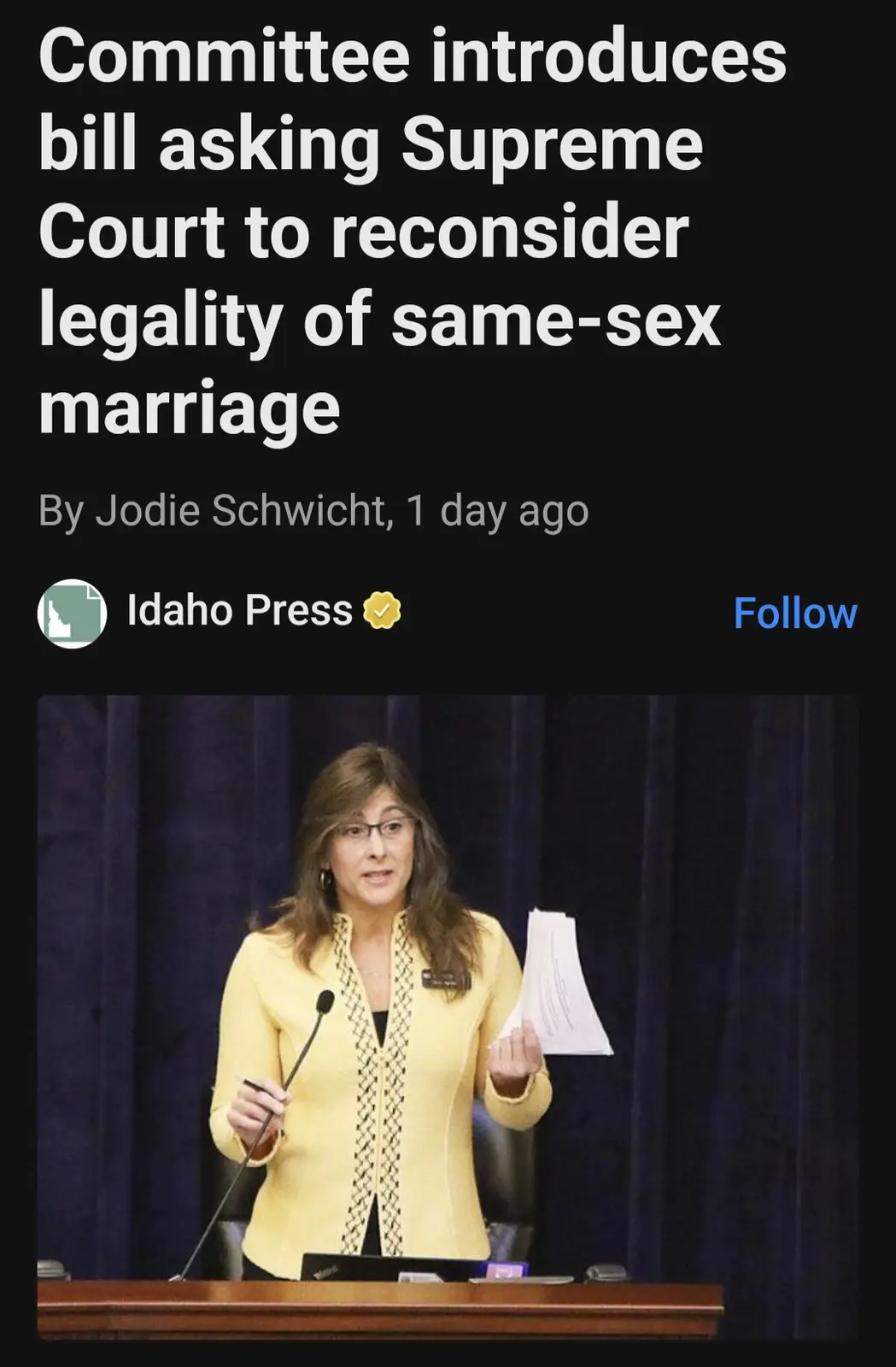 A screenshot of a news article from the Idaho Press, featuring a photo of a woman in a yellow jacket speaking at a podium…