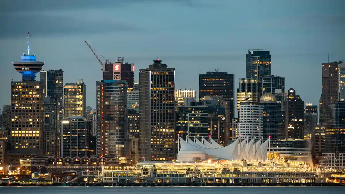As twilight descends, Vancouver's skyline transforms into a canvas of twinkling lights. Iconic Canada Place stands tall, its…