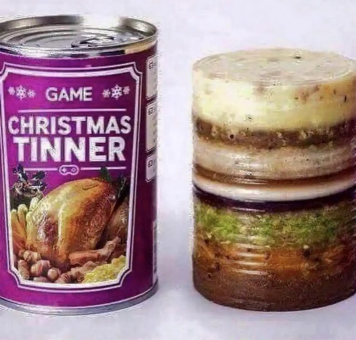 A can labeled 'GAME CHRISTMAS TINNER' with an image of a roasted turkey sits next to an open can revealing a layered…