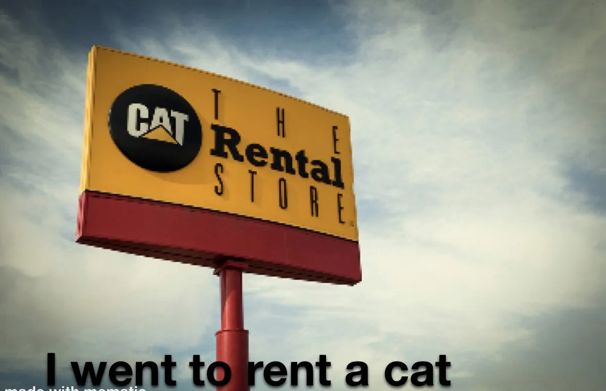 A large yellow and red sign for 'The Rental Store' with the CAT logo, overlaid with the text 'I went to rent a cat'. The…