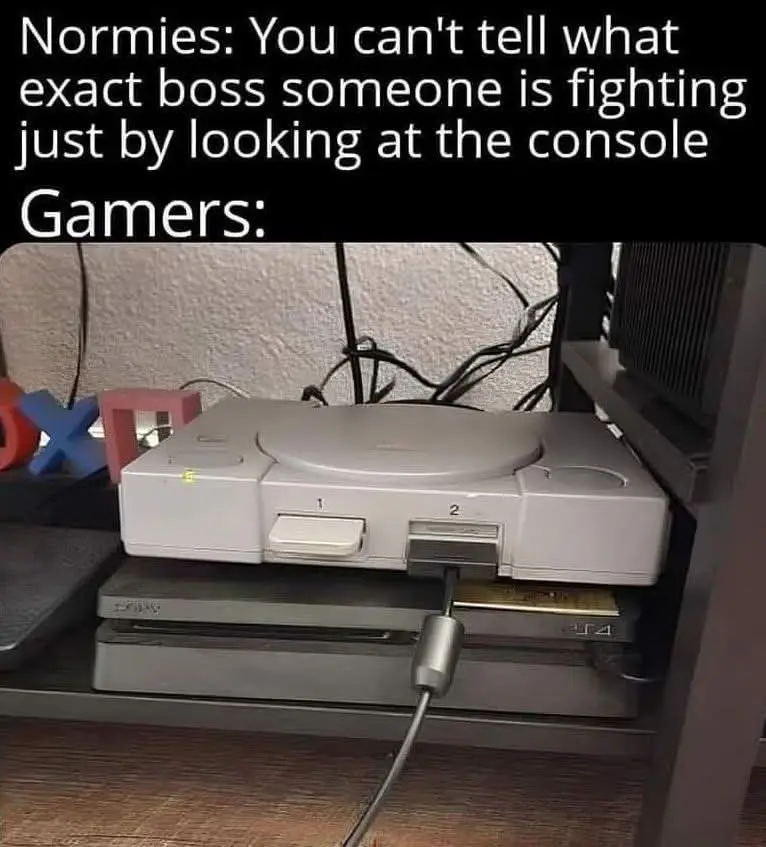 An image shows a white PlayStation 1 console stacked on top of a black PlayStation 4 console, with a cable plugged into the…