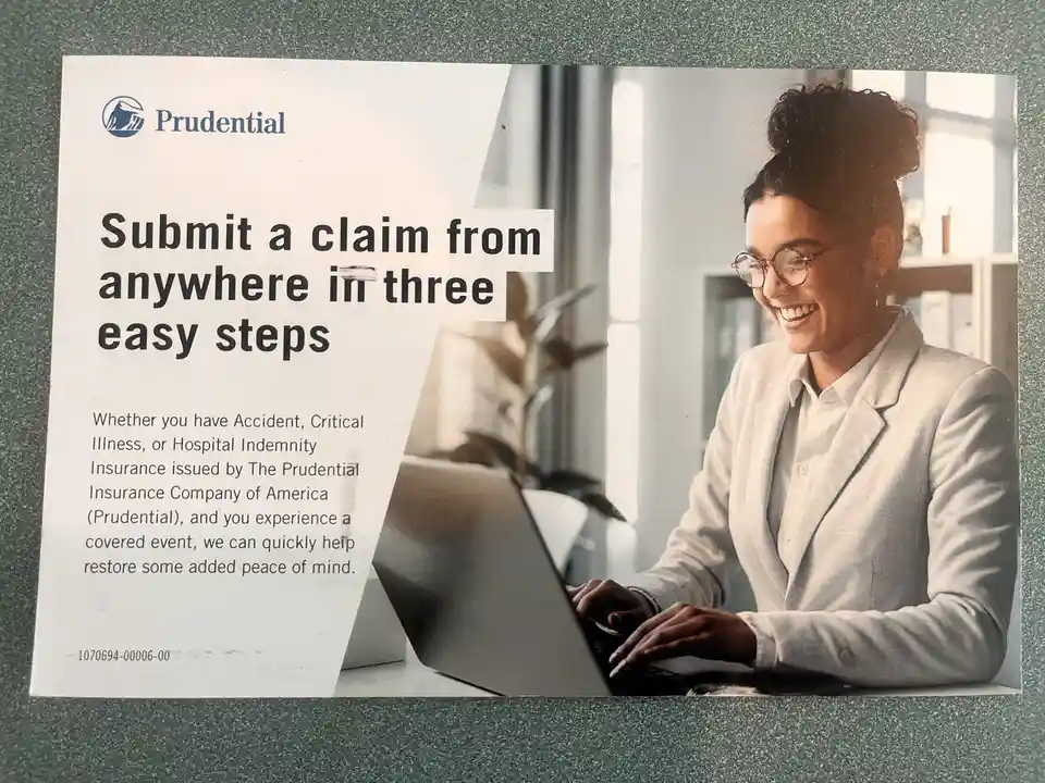 A Prudential insurance advertisement shows a smiling woman in a blazer and glasses typing on a laptop. The ad text promotes…