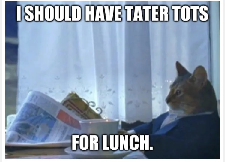 A cat wearing a suit sits at a table with a newspaper and a bowl of food, looking regretful. The text overlaid on the image…