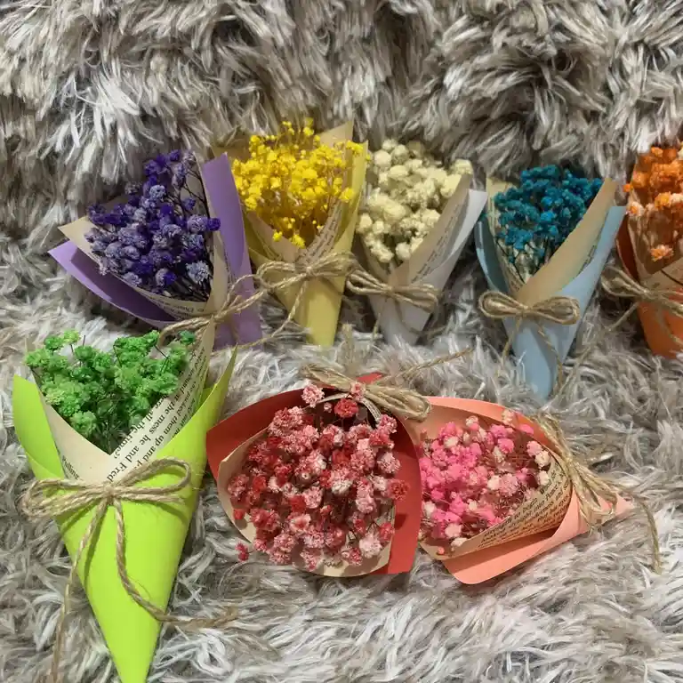 Several small, cone-shaped bouquets of dried flowers in various colors — purple, yellow, white, blue, green, red, and pink…