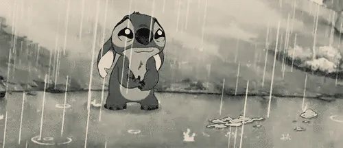 The image shows Stitch from Disney's Lilo & Stitch standing in the rain, visibly sad and crying, with water droplets falling…