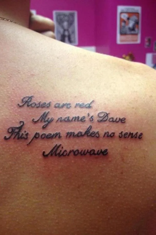 A close-up photo shows a tattoo on a person's upper back, featuring four lines of cursive text that read 'Roses are red'…