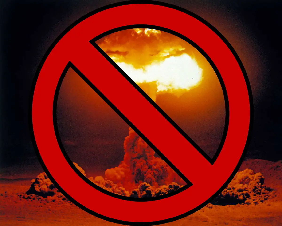 A large red prohibition symbol (circle with diagonal line) is superimposed over a photograph of a volcanic eruption with a…