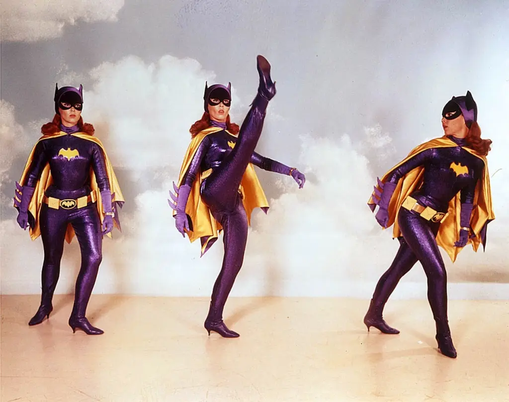 Three sequential photos of a woman in a purple and yellow Batwoman costume with high heels, posing in increasingly dynamic…