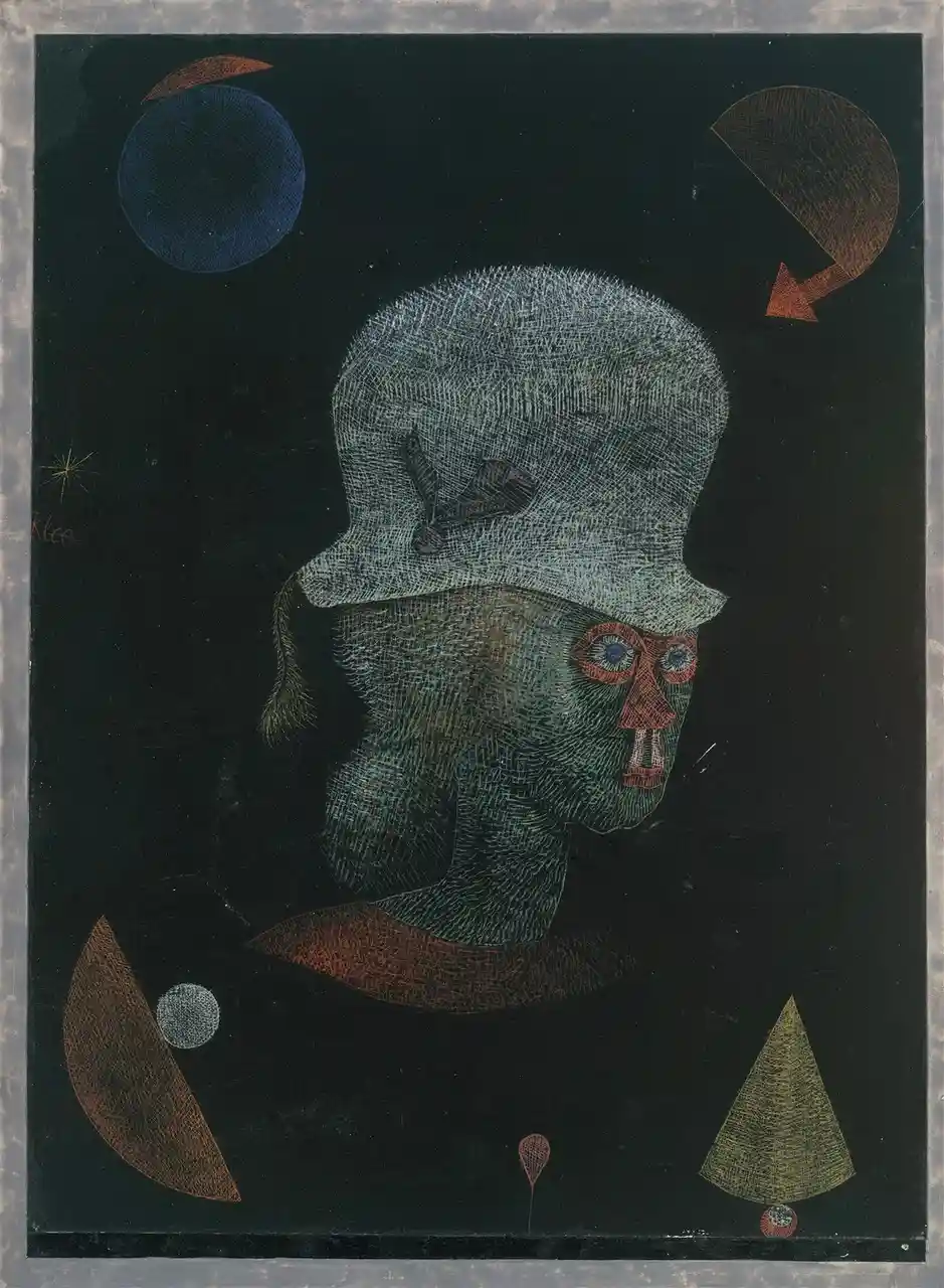 A surreal painting by Paul Klee depicts a green-skinned, top-hatted figure with red-rimmed eyes and a protruding tongue…