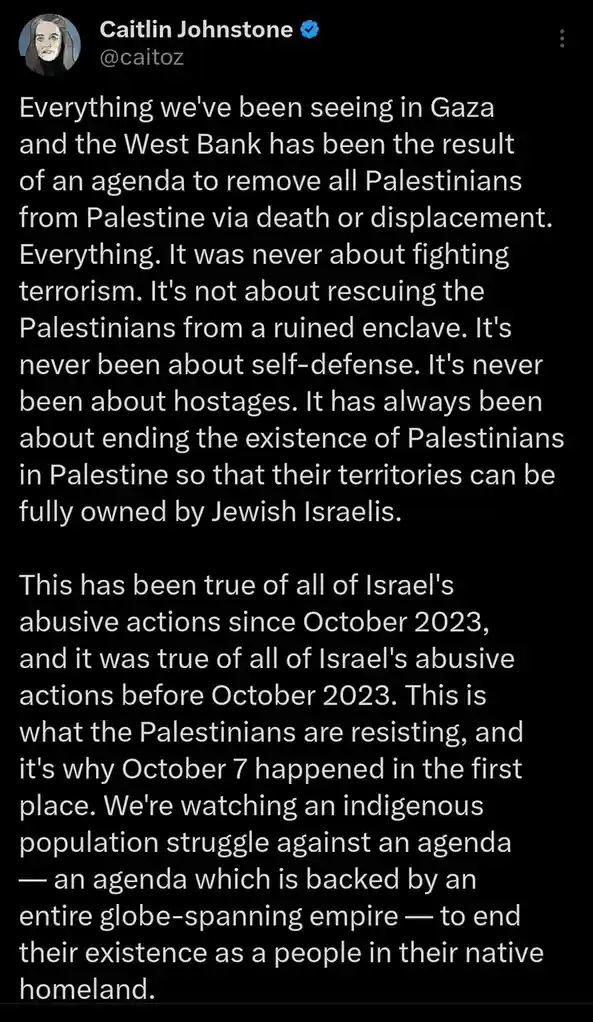 A screenshot of a tweet by Caitlin Johnstone (@caitoz) with a black background and white text. The text is a lengthy…