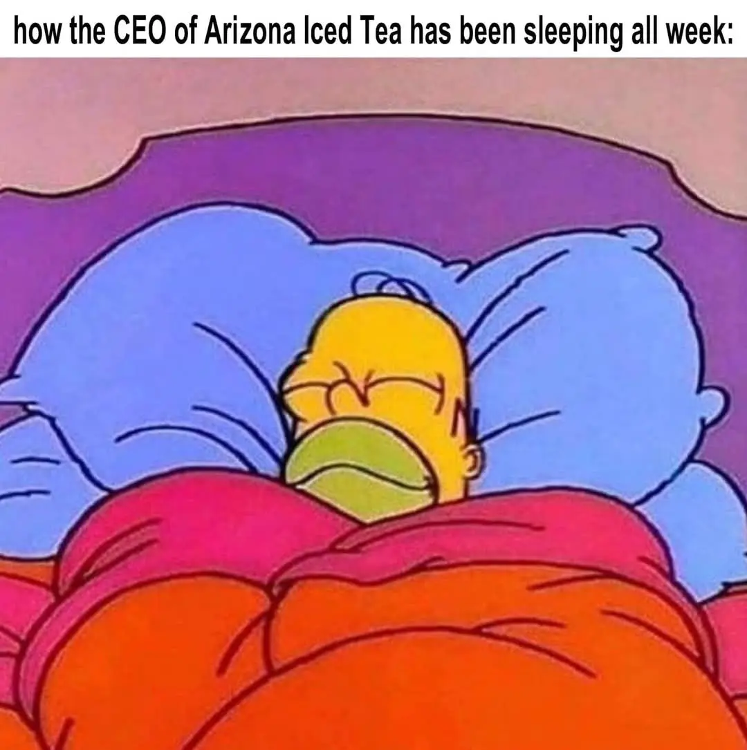 A cartoon image shows Homer Simpson sleeping soundly in bed, buried under orange blankets with blue pillows and a purple…