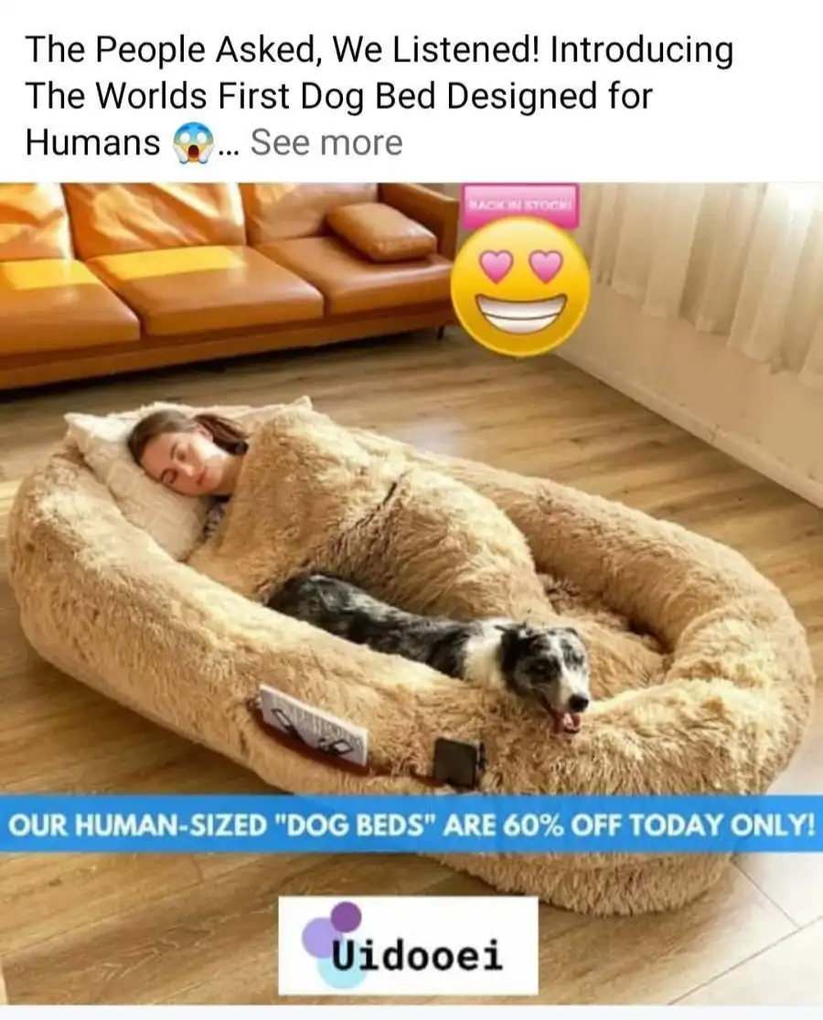 A woman and a dog are sleeping in a large, fluffy, dog-shaped bed that is clearly oversized for a dog. The image is overlaid…