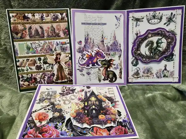 Four decorative cards featuring fantasy stickers like dragons, fairies, castles, and gothic houses, arranged on a green…