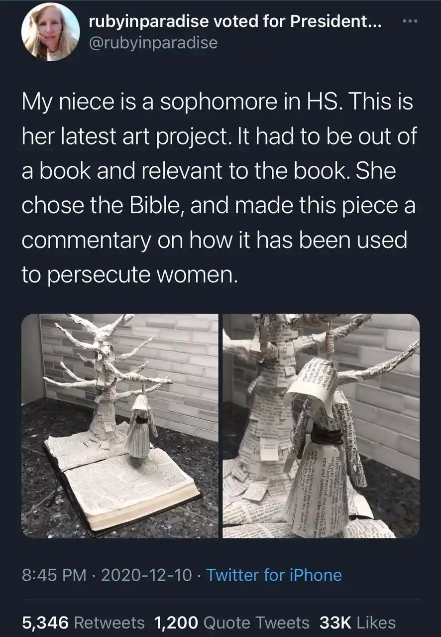 A tweet shows two photos of an art project made from pages of a Bible. The project depicts a tree with a figure hanging from…