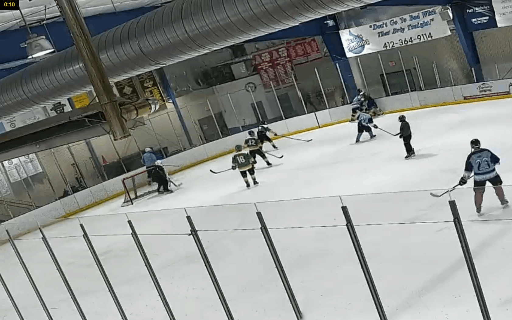 A six-panel sequence from an indoor ice hockey rink shows a young player in a blue jersey with the number 28 standing still…