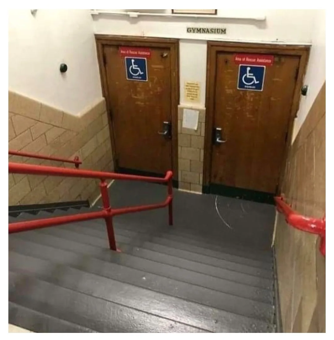 A photo shows two wooden doors at the top of a staircase, each marked with a red sign reading 'King of Rescue Assistance'…