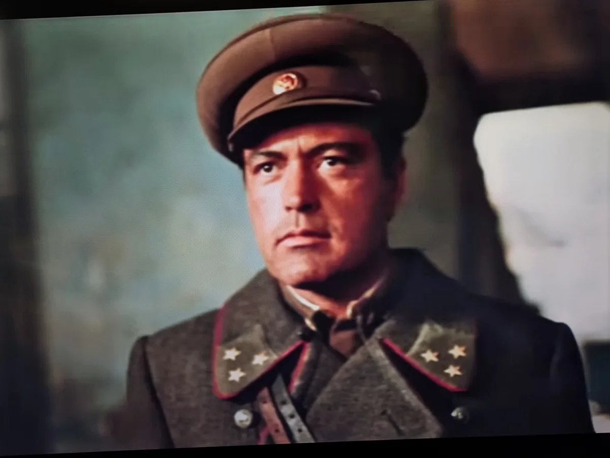 A man in a military uniform with a cap and stars on his collar looks sternly at the camera. The overlaid text reads 'i'm not…