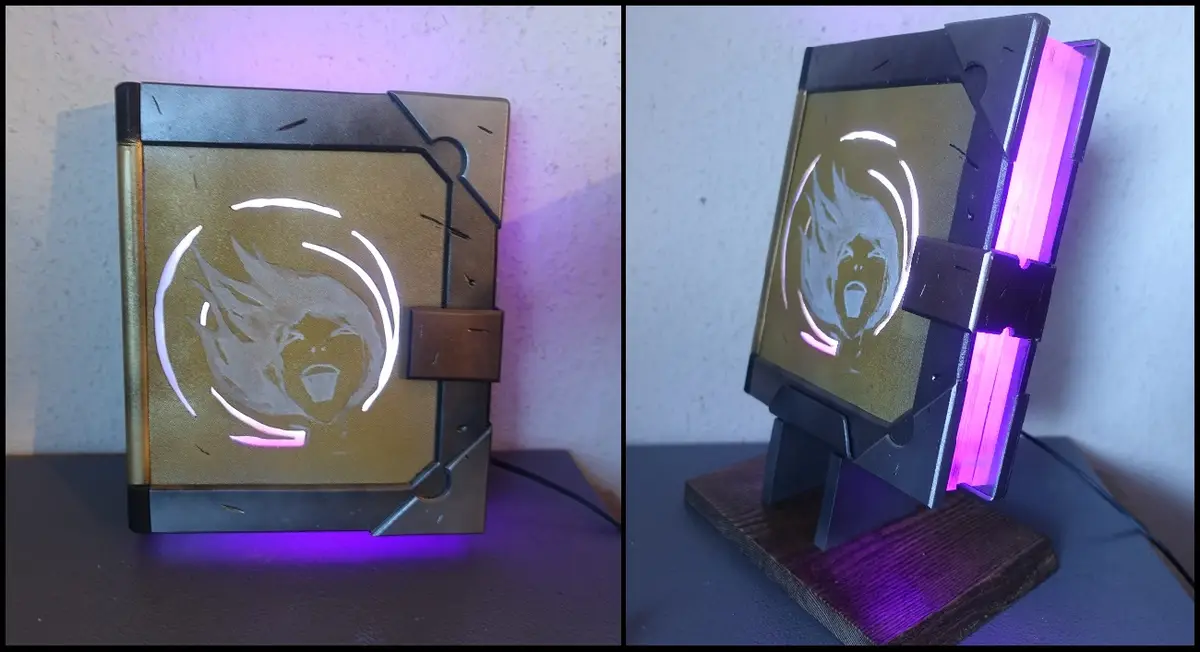 The image displays a custom-made, illuminated lamp shaped like a book, featuring a cutout silhouette of the League of…