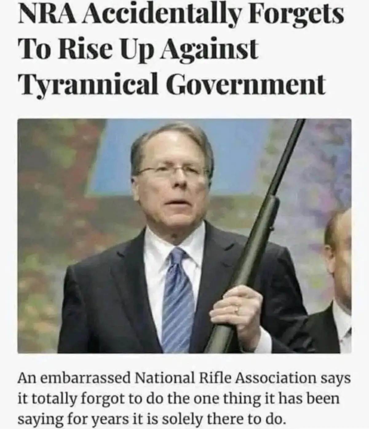 The image shows a man in a suit and tie holding a rifle, with a headline above reading 'NRA Accidentally Forgets To Rise Up…