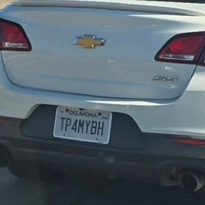 The rear of a light-colored Chevrolet SS is shown, featuring a Oklahoma license plate with the alphanumeric sequence…