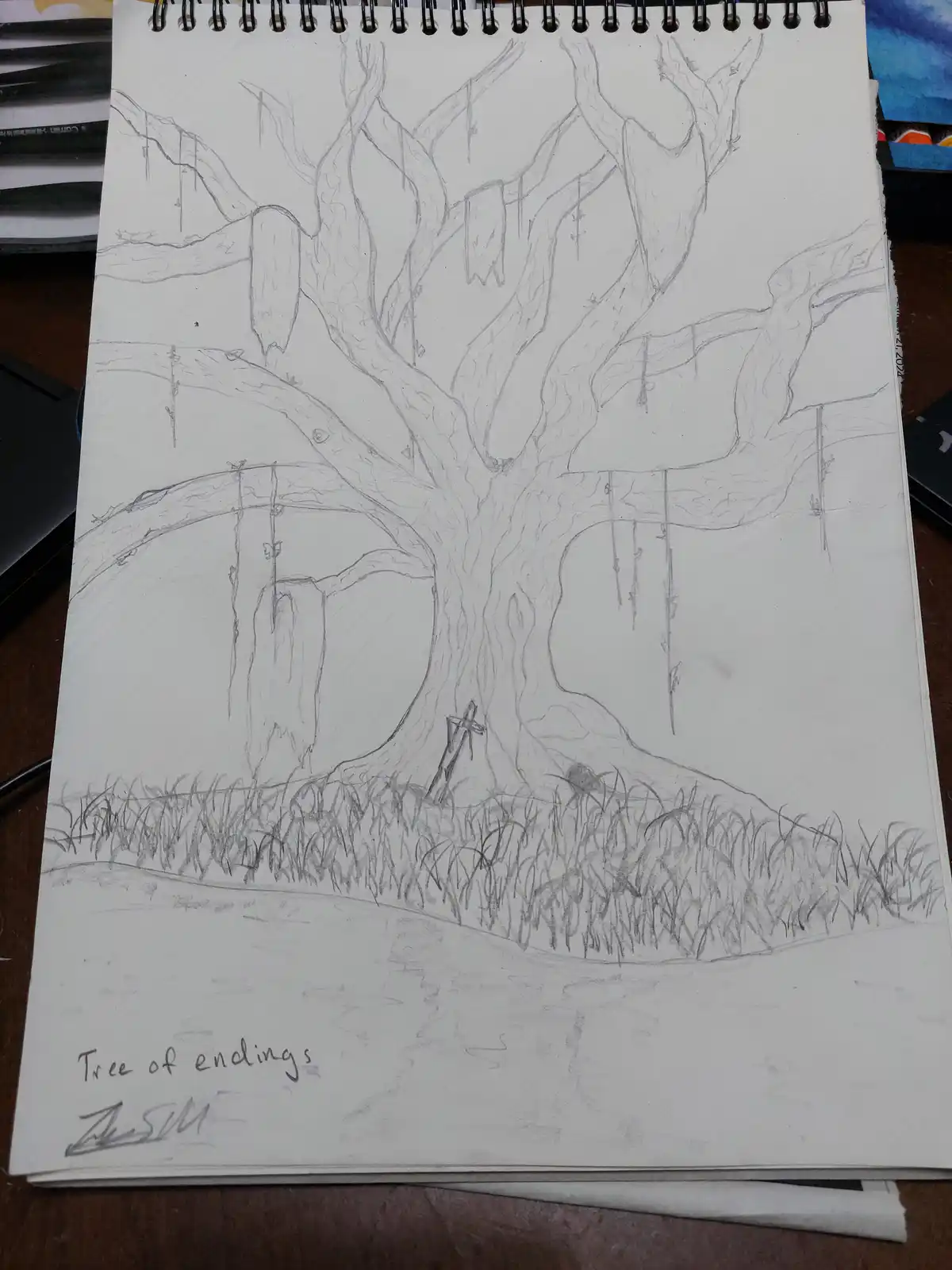 A pencil sketch in a spiral-bound notebook depicts a large, gnarled, leafless tree with numerous branches, each ending in a…