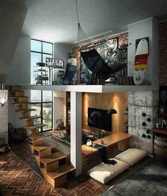 a modern, stylish loft apartment with a mezzanine level, wooden staircase, exposed brick walls, and a surfboard mounted on…