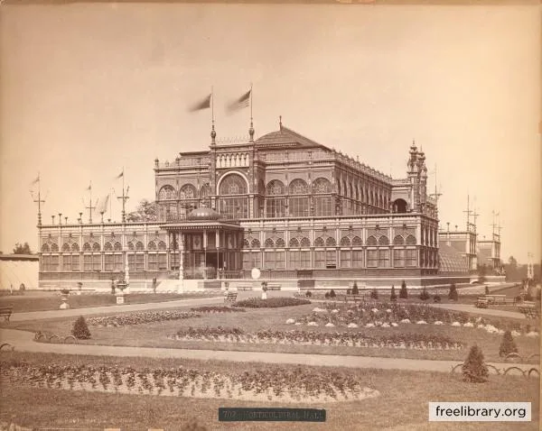 An old sepia-toned photograph shows a grand, ornate, multi-story building with arched windows and flags, surrounded by…