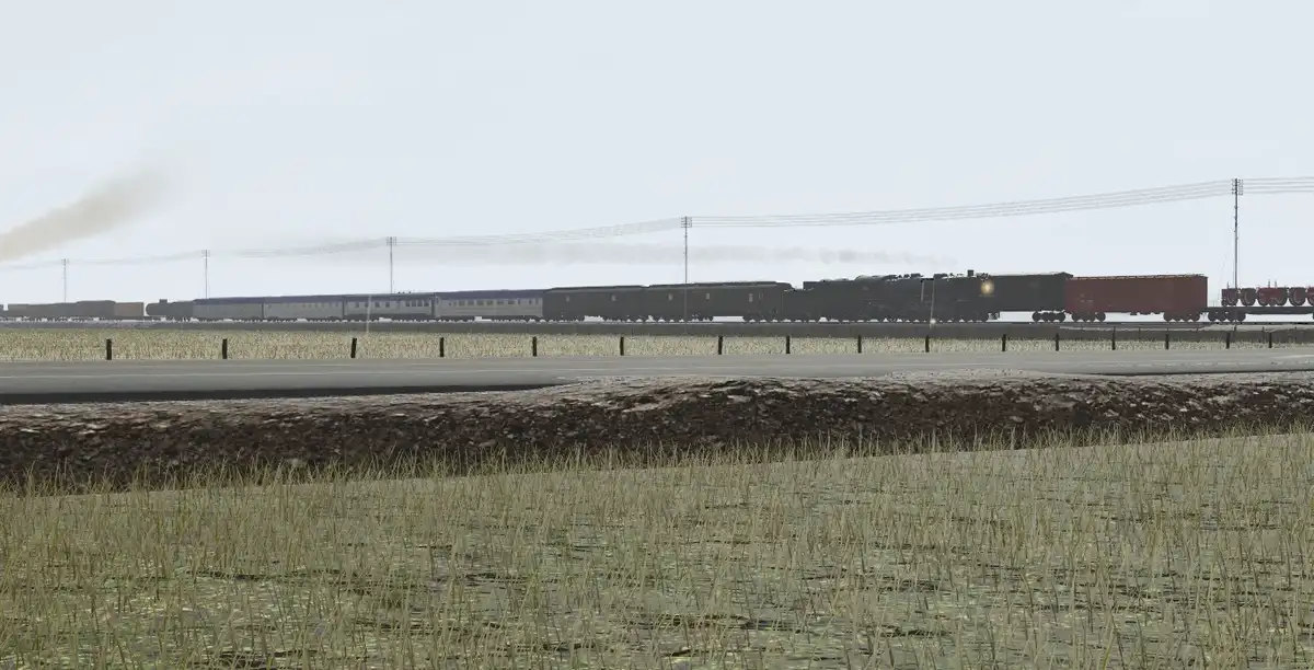 A long freight train with a steam locomotive at the front is visible in the distance, moving across a flat, rural landscape…