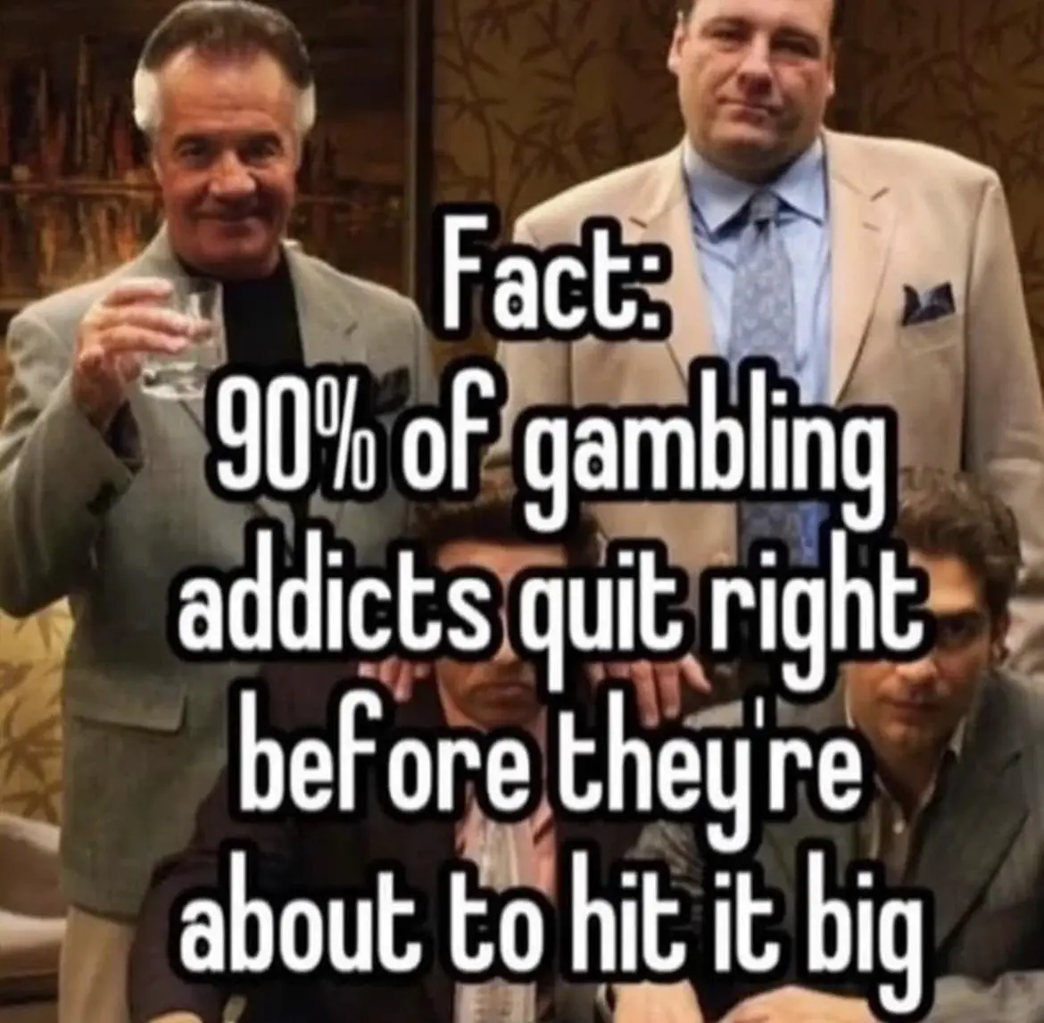The image shows four men in suits from the TV show 'The Sopranos'. One man on the left holds a glass of water, another…