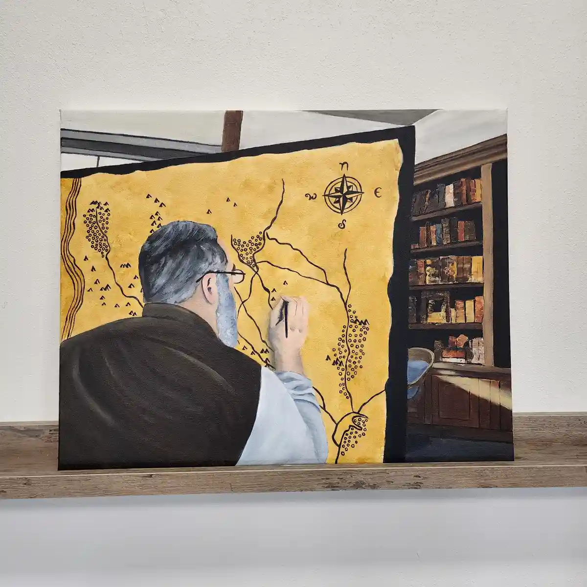 A painting depicts a man with gray hair and beard, wearing glasses and a brown robe, drawing on a large yellow map with a…