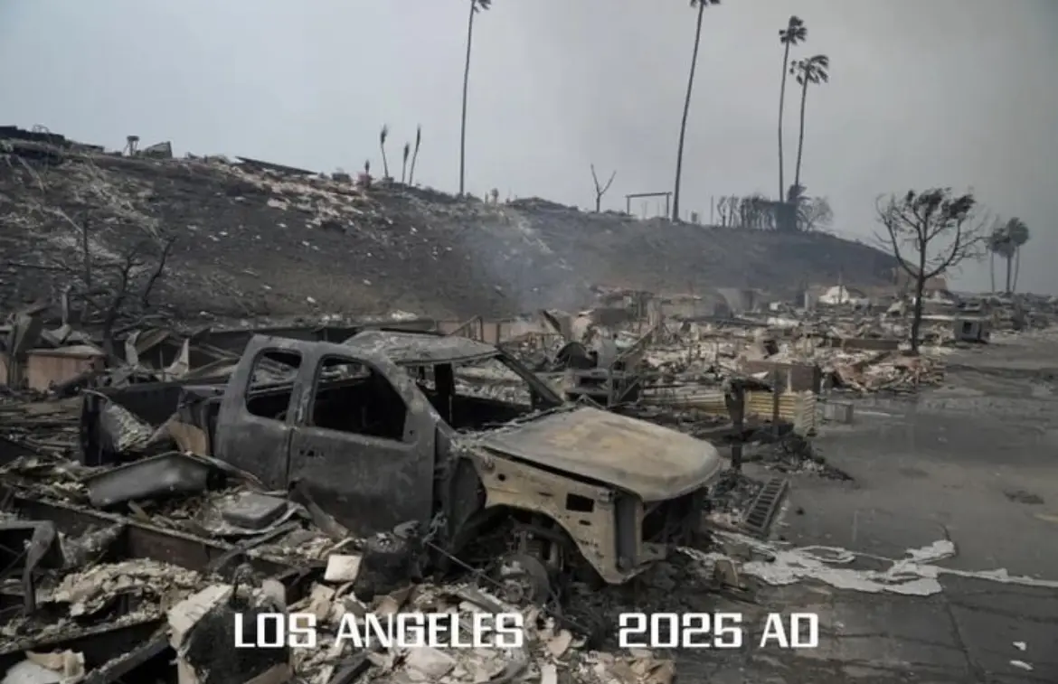 A desolate, ash-covered landscape shows the charred remains of a pickup truck and destroyed buildings, with burnt palm trees…