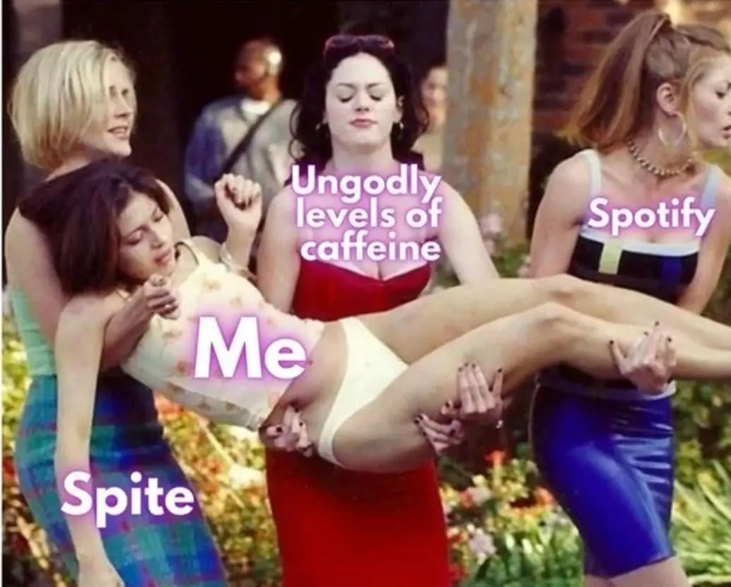 Three women carry a fourth woman who is labeled 'Me' in a scene from the movie 'Mean Girls'. The woman labeled 'Me' is limp…