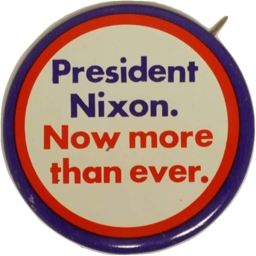 A vintage circular political campaign button with a red and blue border, featuring the text 'President Nixon.' in dark blue…
