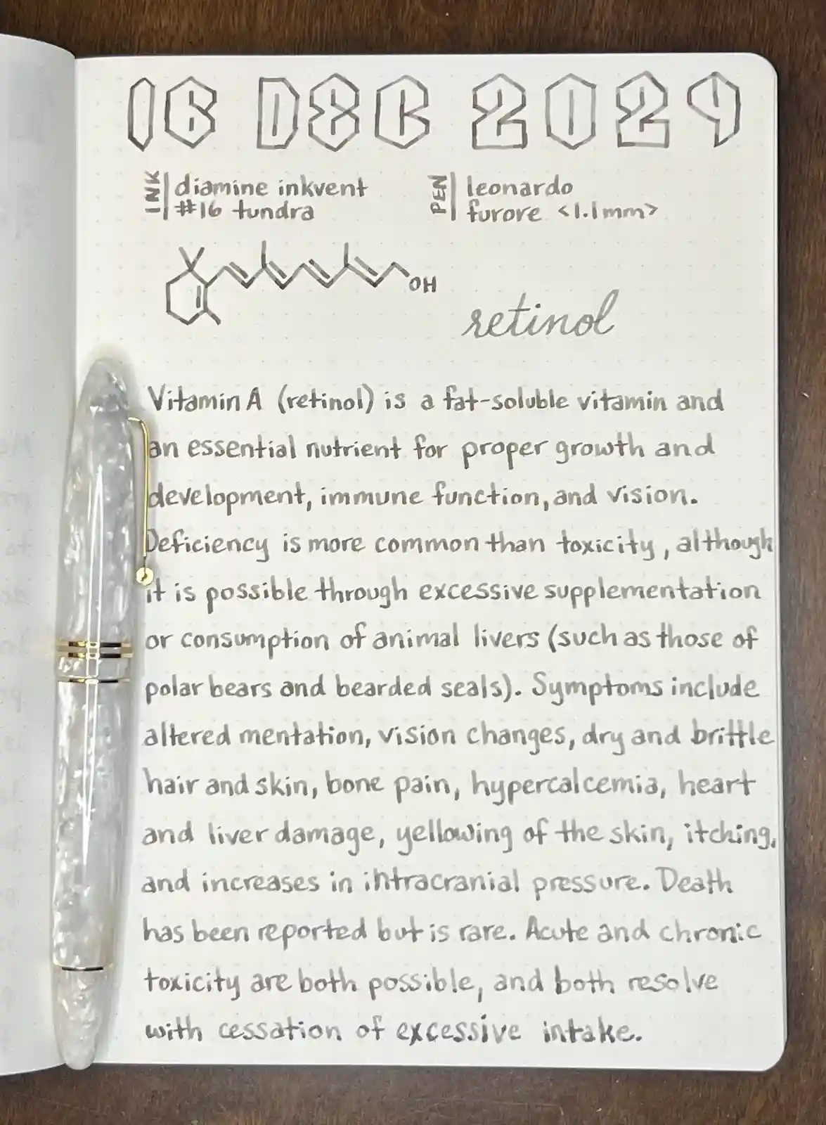 A handwritten notebook page dated 16 DEC 2029, detailing the chemical structure and medical facts about retinol (Vitamin A)…