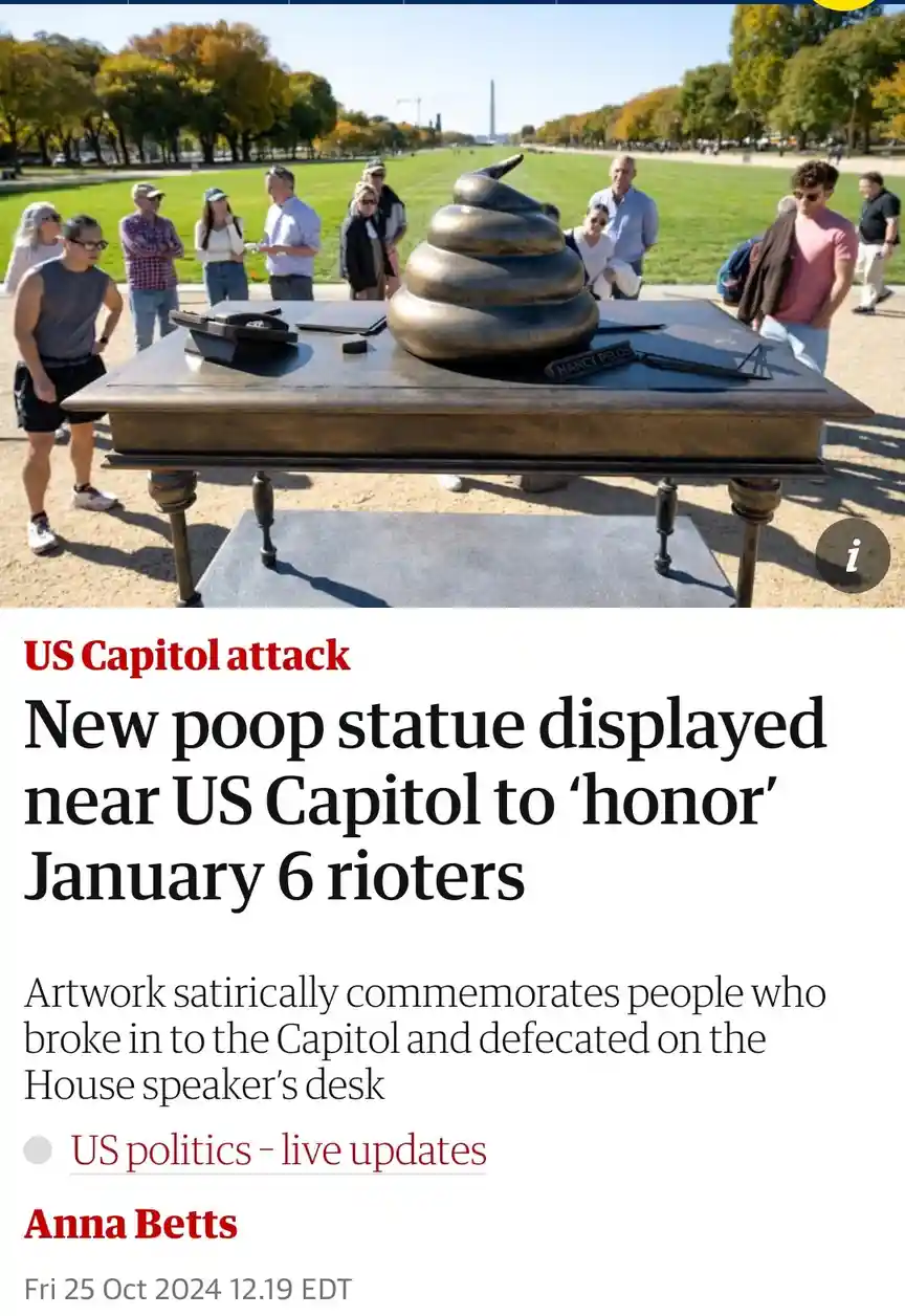 A bronze sculpture shaped like a pile of poop sits atop a replica of a desk, with a plaque reading 'NANCY PELOS' and…
