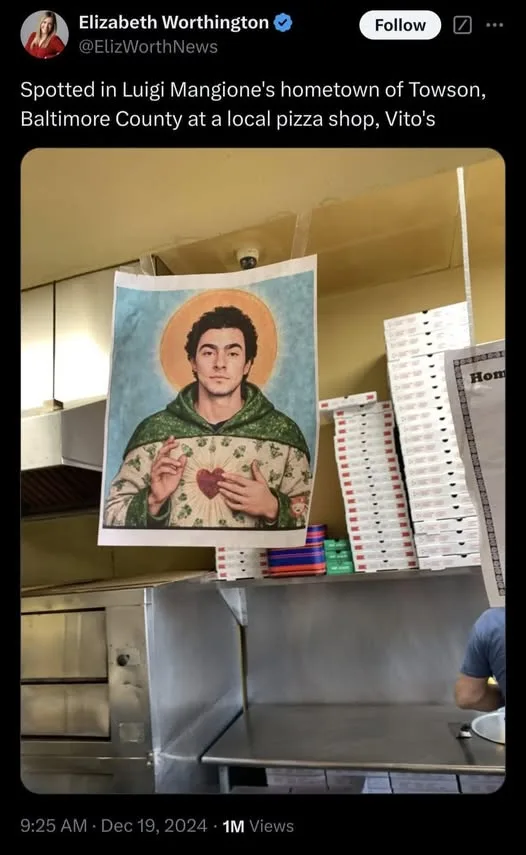 A poster of Luigi Mangione, digitally altered to resemble a saint with a halo and a heart over his chest, is taped to a wall…